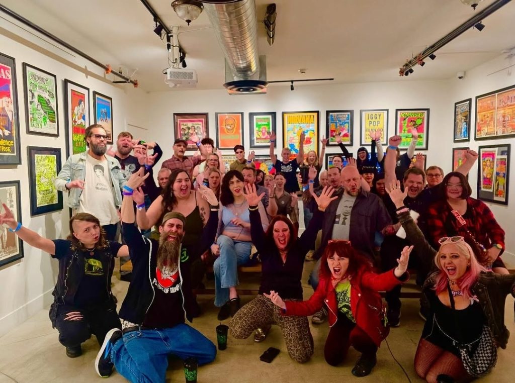 Jennifer Finch and her tour group posing for a photo at The Punk Rock Museum.