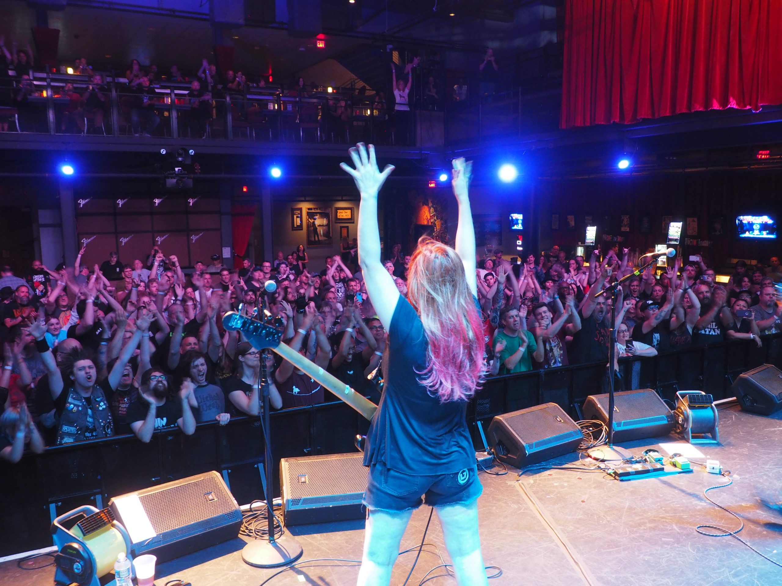 Jennifer finch holding hands on on stage in front of a big audience
